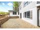 The back exterior shows stone retaining walls, a paver patio, and white siding with gray shutters at 5361 Seaton Way, Dunwoody, GA 30338
