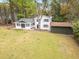 Aerial view of the home's backyard, outbuilding, mature trees, and surrounding greenery at 5361 Seaton Way, Dunwoody, GA 30338
