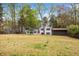 The home features a spacious backyard, sunroom, and outbuilding nestled among mature trees at 5361 Seaton Way, Dunwoody, GA 30338