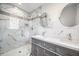 Bathroom featuring double vanity, marble tile, and glass enclosed shower at 5361 Seaton Way, Dunwoody, GA 30338