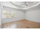 Spacious bedroom features hardwood floors, a ceiling fan, and tray ceiling at 5361 Seaton Way, Dunwoody, GA 30338