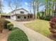Two-story home featuring a brick driveway leading to a covered porch and landscaped front yard at 5361 Seaton Way, Dunwoody, GA 30338