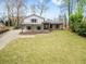 Charming home featuring a large front lawn, welcoming porch, and classic architectural details at 5361 Seaton Way, Dunwoody, GA 30338