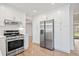 Bright kitchen featuring stainless steel appliances, white cabinets, and hardwood floors at 5361 Seaton Way, Dunwoody, GA 30338