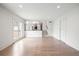 Spacious living room with hardwood floors, white walls, and access to the kitchen at 5361 Seaton Way, Dunwoody, GA 30338