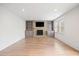 Cozy living room with a stone fireplace, built-in shelves, and hardwood floors at 5361 Seaton Way, Dunwoody, GA 30338