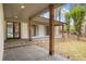 Covered porch boasts natural wood columns and gray tile flooring at 5361 Seaton Way, Dunwoody, GA 30338