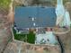 Aerial shot showcasing the backyard with patio, lawn, and mature trees surrounding the property at 1445 Bentcreek Dr, Marietta, GA 30062