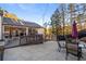 Outdoor kitchen and lounge space off of a large concrete patio with steps leading up to artificial turf at 1445 Bentcreek Dr, Marietta, GA 30062