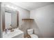 A cozy bathroom includes a toilet, sink, and mirror with modern fixtures at 1445 Bentcreek Dr, Marietta, GA 30062