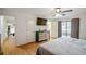 Bedroom featuring wood floors, television, ceiling fan, and access to balcony at 1445 Bentcreek Dr, Marietta, GA 30062