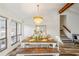 Bright dining area with a rustic wooden table and bench seating underneath an ornate chandelier fixture at 1445 Bentcreek Dr, Marietta, GA 30062