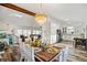 Dining area with a farmhouse table, statement chandelier, and seamlessly flowing into the modern kitchen at 1445 Bentcreek Dr, Marietta, GA 30062