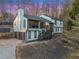 Beautiful home at dusk featuring an attached garage, mature trees, and a well-manicured lawn at 1445 Bentcreek Dr, Marietta, GA 30062