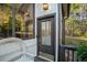 Close up of front entrance door, porch, and window, with mature trees at 1445 Bentcreek Dr, Marietta, GA 30062