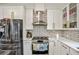 Updated kitchen featuring stainless steel appliances, white cabinets with gold hardware, and subway tile backsplash at 1445 Bentcreek Dr, Marietta, GA 30062