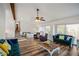 Living room with wood floors, ceiling fan, fireplace and many windows allowing natural light at 1445 Bentcreek Dr, Marietta, GA 30062