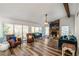 Bright living room with vaulted ceiling, fireplace, ceiling fan and wood laminate flooring at 1445 Bentcreek Dr, Marietta, GA 30062