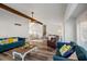 Bright living room featuring wood flooring, exposed beam, ceiling fan, and comfortable furnishings with colorful pillows at 1445 Bentcreek Dr, Marietta, GA 30062