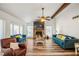 Spacious living room features a stone fireplace, ceiling fan, and wood flooring at 1445 Bentcreek Dr, Marietta, GA 30062