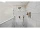 A tiled shower has a shower head, and a handheld wand at 1445 Bentcreek Dr, Marietta, GA 30062
