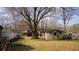 The backyard has a large tree and building in the background at 1751 Tiger Flowers Nw Dr, Atlanta, GA 30314