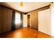 The bedroom has a window, hardwood floors, and vertical wood paneling at 1751 Tiger Flowers Nw Dr, Atlanta, GA 30314