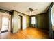 The bedroom has a ceiling fan, hardwood floors, and vertical wood paneling at 1751 Tiger Flowers Nw Dr, Atlanta, GA 30314