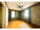 The bedroom has two windows, hardwood floors, and vertical wood paneling at 1751 Tiger Flowers Nw Dr, Atlanta, GA 30314