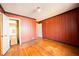 The bedroom has hardwood floors and vertical wood paneling at 1751 Tiger Flowers Nw Dr, Atlanta, GA 30314