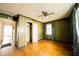 The bedroom has a ceiling fan, hardwood floors, and vertical wood paneling at 1751 Tiger Flowers Nw Dr, Atlanta, GA 30314