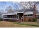 Close up of a classic brick home with screened in porch at 1751 Tiger Flowers Nw Dr, Atlanta, GA 30314