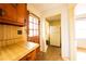 A kitchen with vintage wood cabinets, sink, and a view to the backyard at 1751 Tiger Flowers Nw Dr, Atlanta, GA 30314