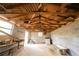 Outbuilding interior featuring unfinished walls, exposed ceiling, concrete flooring, and a window at 1751 Tiger Flowers Nw Dr, Atlanta, GA 30314