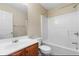 Bright bathroom featuring a tub-shower, large mirror, and vanity with wood cabinets at 201 Creel Way, Atlanta, GA 30349