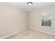 Bedroom features neutral carpet, a window with blinds, and is freshly painted at 201 Creel Way, Atlanta, GA 30349