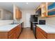 Functional kitchen with wood cabinets, black appliances, and laminate countertops at 201 Creel Way, Atlanta, GA 30349
