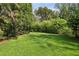 Picturesque backyard featuring a well-maintained lawn and surrounding greenery for a private and serene setting at 2628 Rivers Nw Rd, Atlanta, GA 30305
