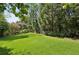 Expansive backyard with lush green lawn and mature trees, perfect for outdoor activities and relaxation at 2628 Rivers Nw Rd, Atlanta, GA 30305