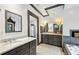 Stylish bathroom featuring dual sinks, marble countertops, and a mosaic-tiled bathtub at 2628 Rivers Nw Rd, Atlanta, GA 30305