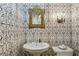 Unique powder room with patterned wallpaper, pedestal sink, and elegant mirror at 2628 Rivers Nw Rd, Atlanta, GA 30305