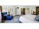 Bright bedroom with a blue accent chair, hardwood floors, and natural light at 2628 Rivers Nw Rd, Atlanta, GA 30305