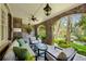 Inviting covered patio with brick archway, comfortable seating, and serene backyard views at 2628 Rivers Nw Rd, Atlanta, GA 30305