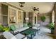 Relaxing covered patio featuring brick walls, comfortable seating, and ceiling fans at 2628 Rivers Nw Rd, Atlanta, GA 30305