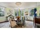 Bright dining room with a large table, chandelier, and multiple windows at 2628 Rivers Nw Rd, Atlanta, GA 30305
