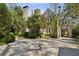 Charming home with brick facade, arched entryway, and lush landscaping, seamlessly blending elegance and nature at 2628 Rivers Nw Rd, Atlanta, GA 30305