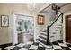 Elegant foyer features a staircase, checkerboard flooring, and living room view at 2628 Rivers Nw Rd, Atlanta, GA 30305