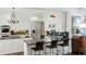 Bright kitchen with stainless steel appliances, an island with seating, and an elegant chandelier at 2628 Rivers Nw Rd, Atlanta, GA 30305