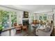 Bright living room featuring fireplace, French doors, and comfortable seating at 2628 Rivers Nw Rd, Atlanta, GA 30305