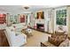 Bright living room with fireplace, built-in bookshelves, and large windows at 2628 Rivers Nw Rd, Atlanta, GA 30305